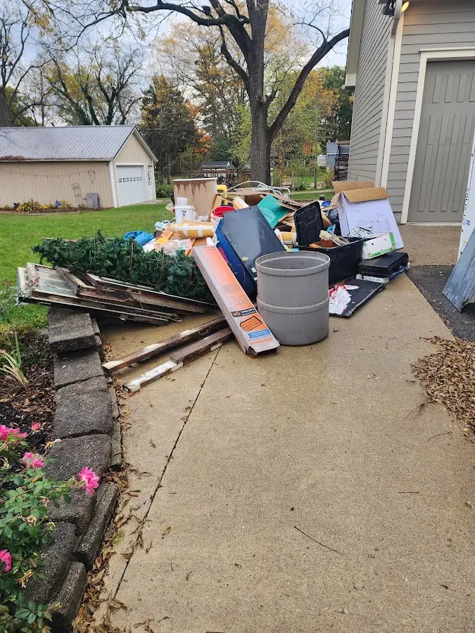 Dumpster being loaded with debris for Residential Dumpster Rental in Helena